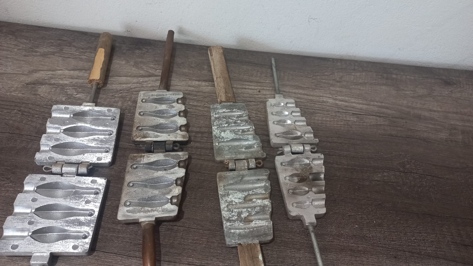 Collection of Four Metal Fishing Sinker Moulds